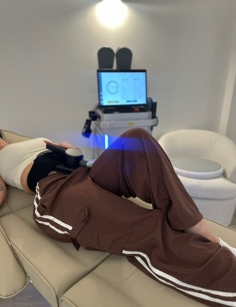 A client with EMS applicators positioned on her abdomen.