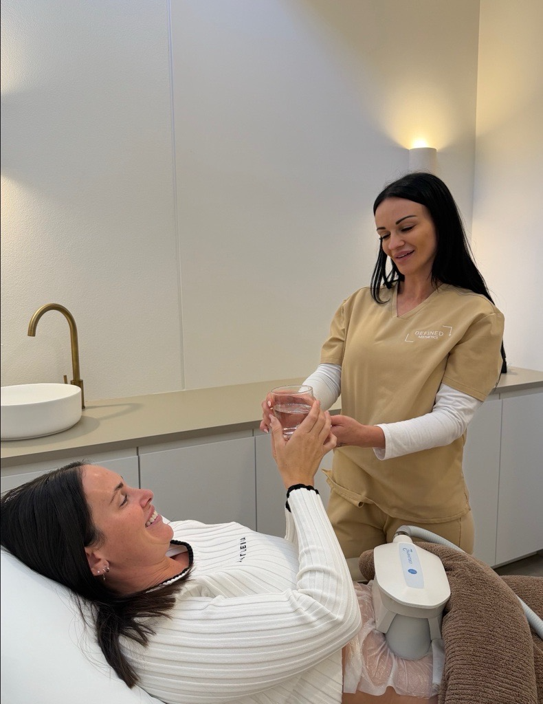 A practitioner checking on a client during a body-treatment appointment.